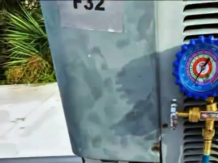 Manifold gauge hooked up to an outdoor AC unit during a refrigerant check