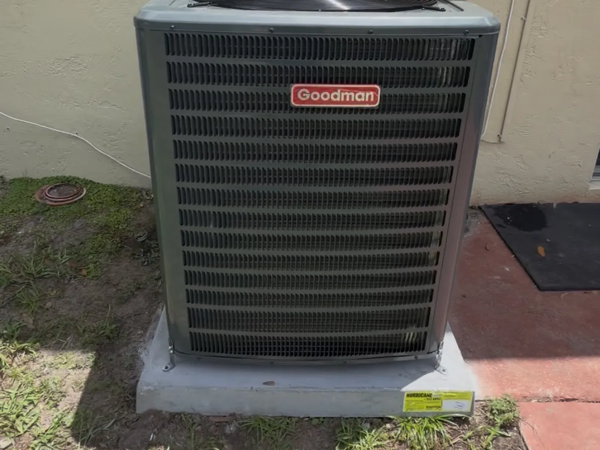 Goodman outdoor condenser on a concrete pad beside a Tampa home