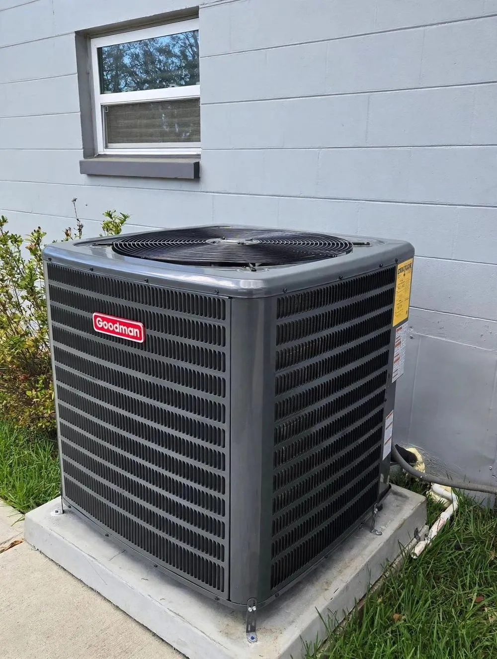 New air conditioning condenser installed on a fresh concrete pad by Mendoza Heating and Air — photo from Instagram