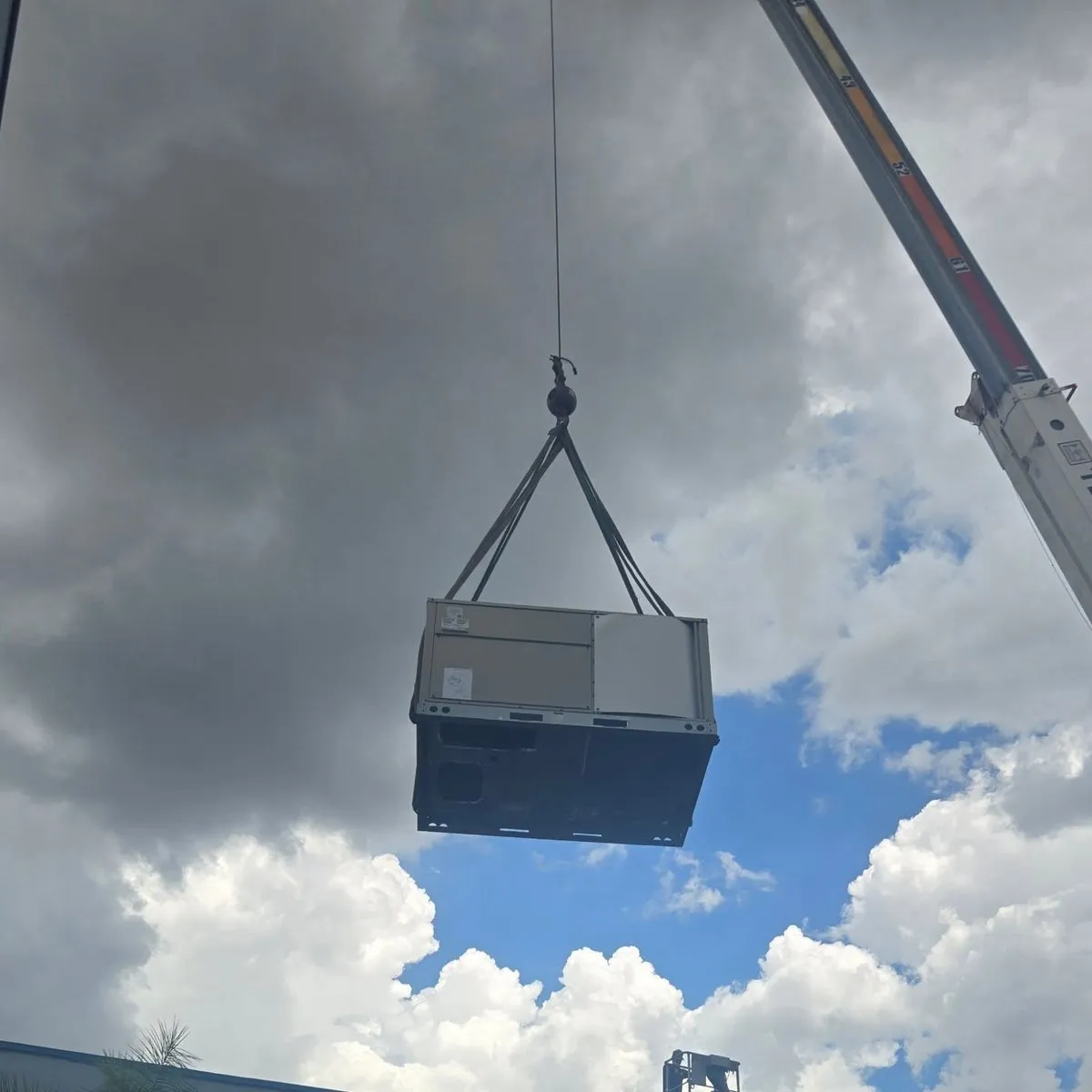 Crane lifting a commercial rooftop HVAC unit on a Mendoza Heating and Air job — photo from Instagram