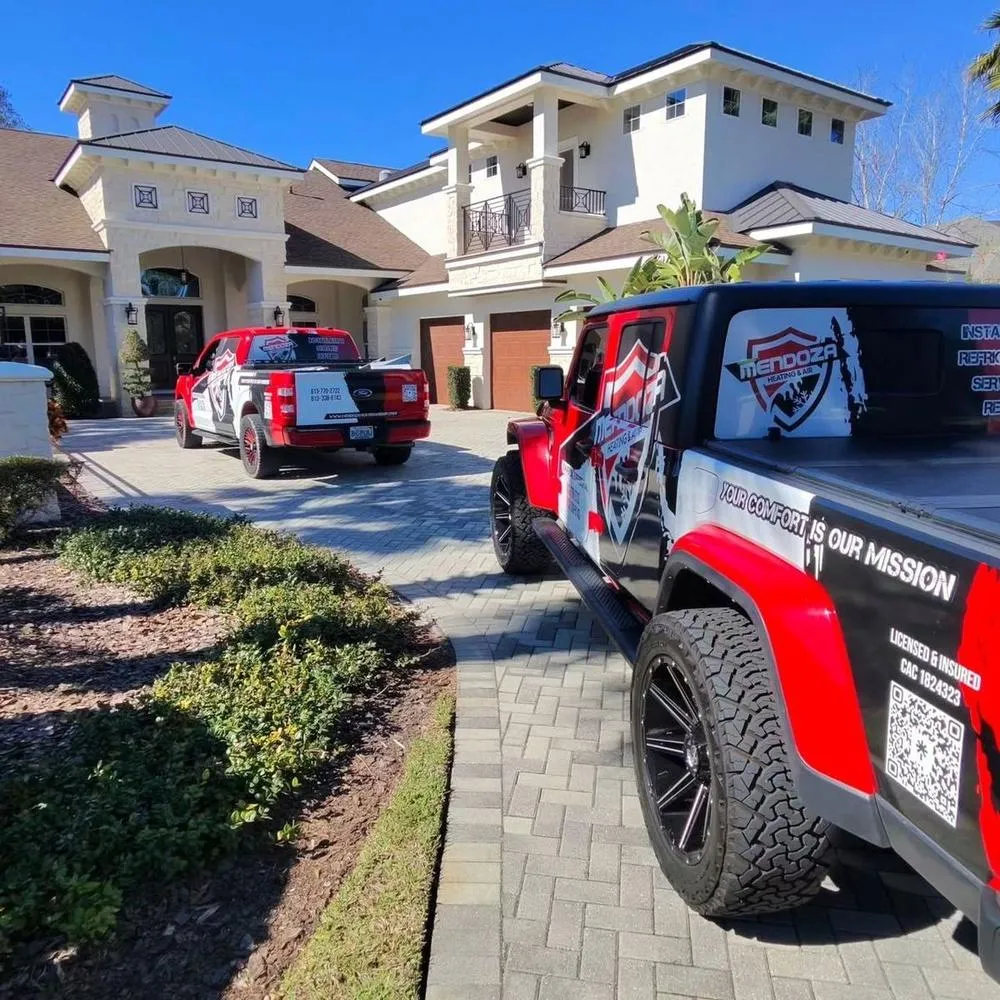 Mendoza Heating and Air trucks at a Riverview home